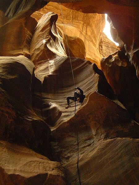 Rappelling down a steep cavern